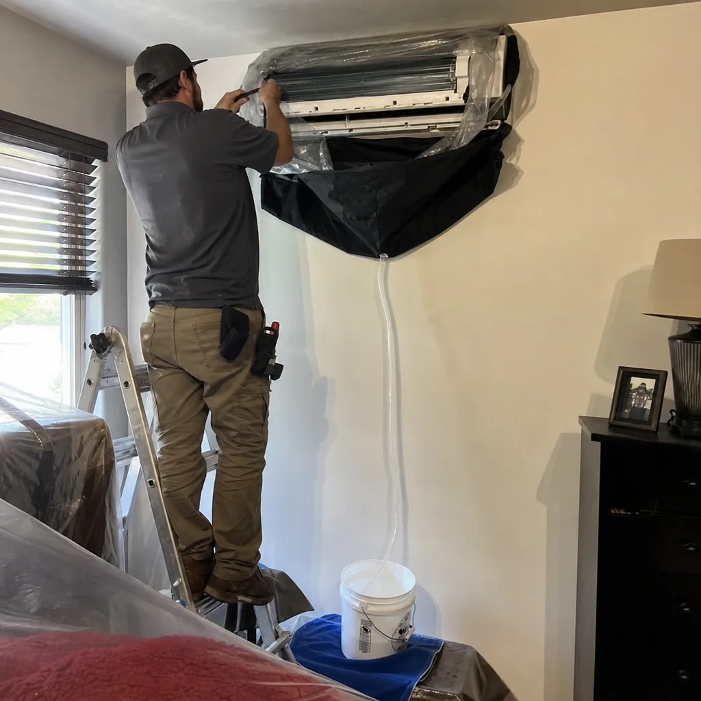 HVAC technician performing professional ductless air conditioner cleaning